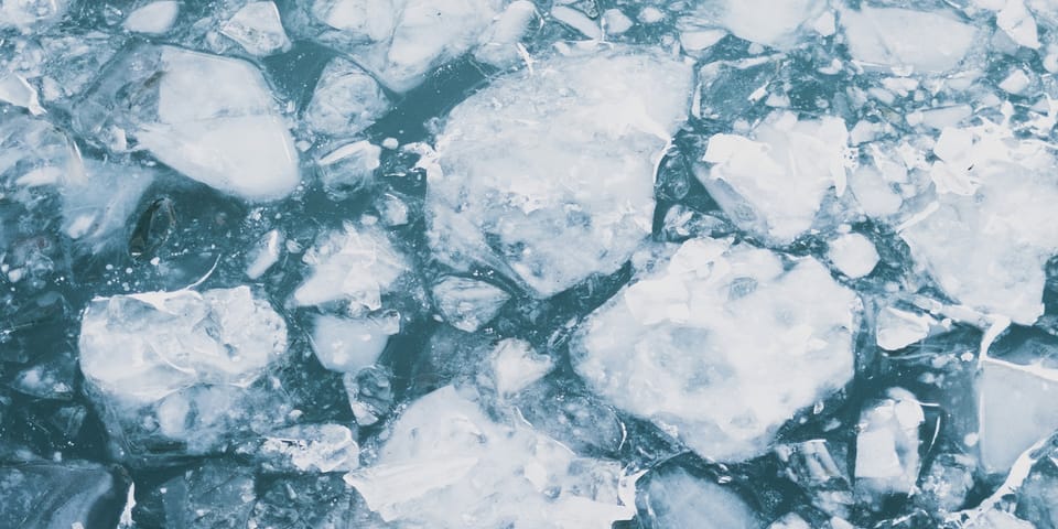 A close-up view of broken ice floating on water.