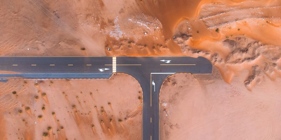 An intersection on a desert road.